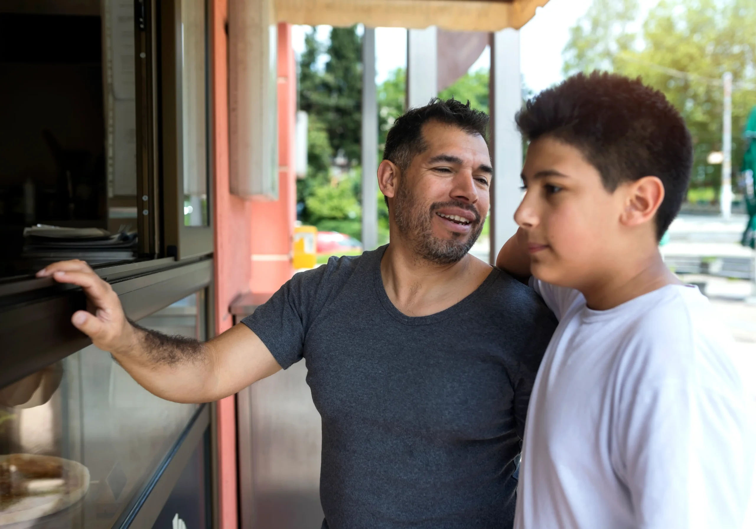 Father and son spending quality time together.Lunch in fast food restaurant.